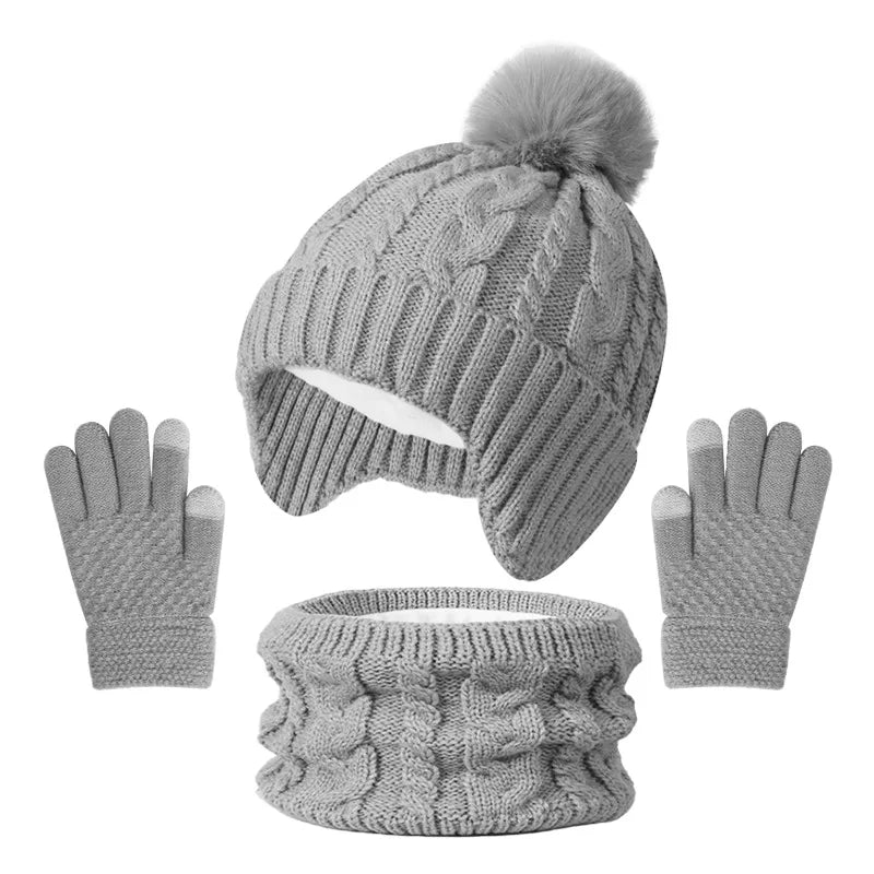 Gray knit beanie with pom-pom, matching gloves, and scarf on a white background
