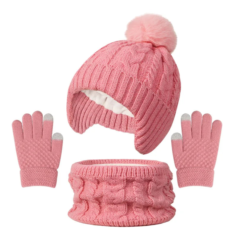 Pink knitted hat, scarf, and gloves set on a white background