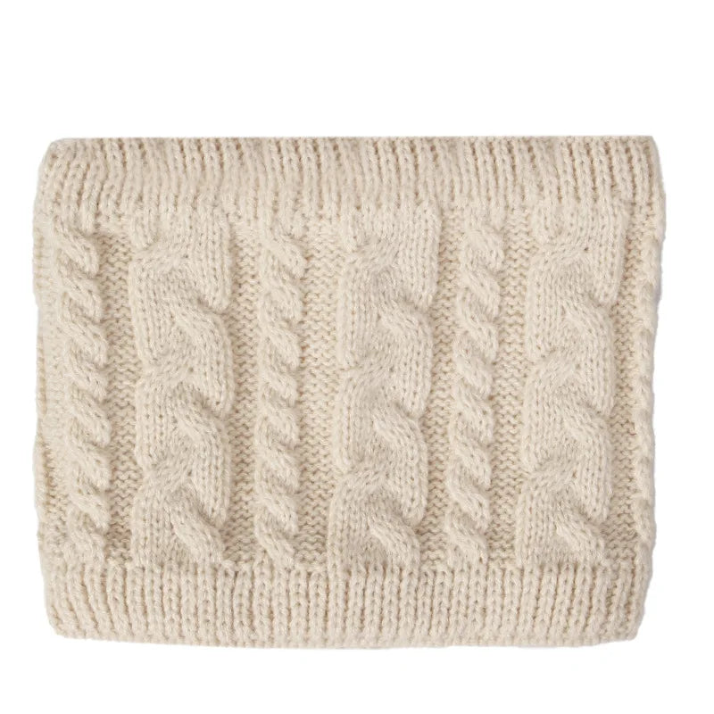 Beige knitted fabric with cable pattern on a white background