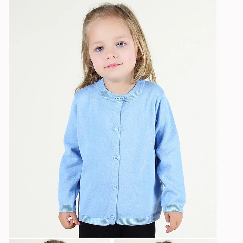 Child wearing a light blue cardigan on a white background
