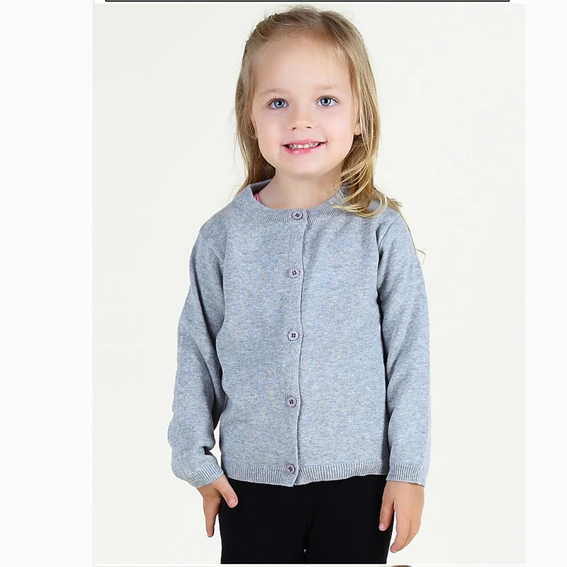 Child wearing a gray cardigan on a white background