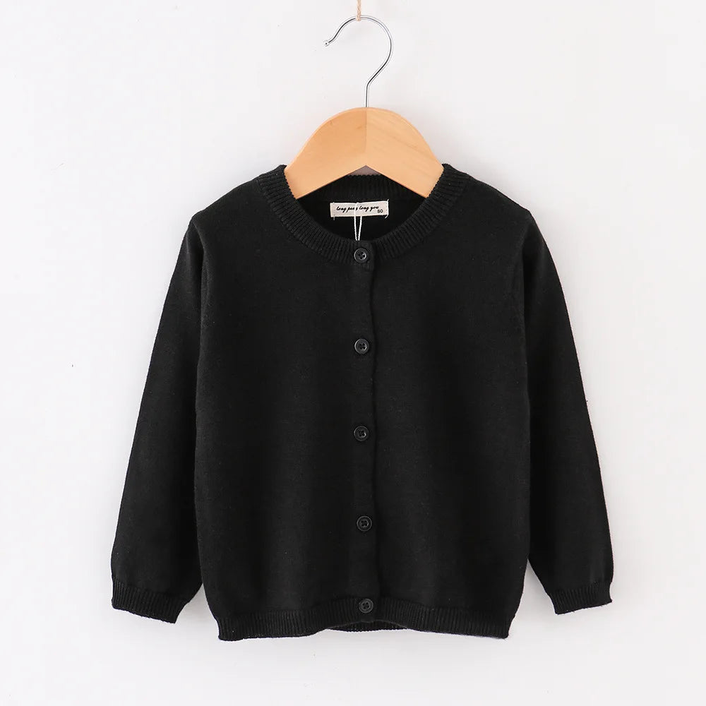 Black cardigan on a wooden hanger against a white background