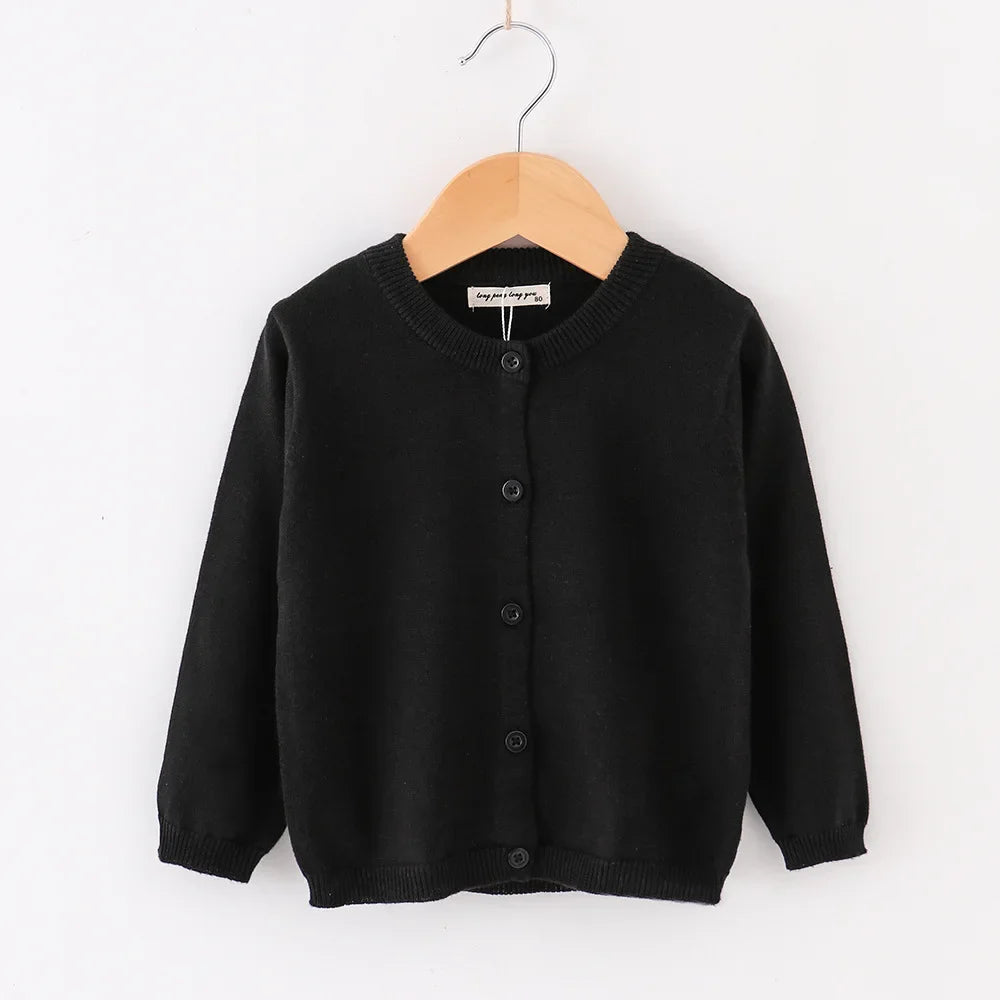 Black cardigan on a wooden hanger against a white background