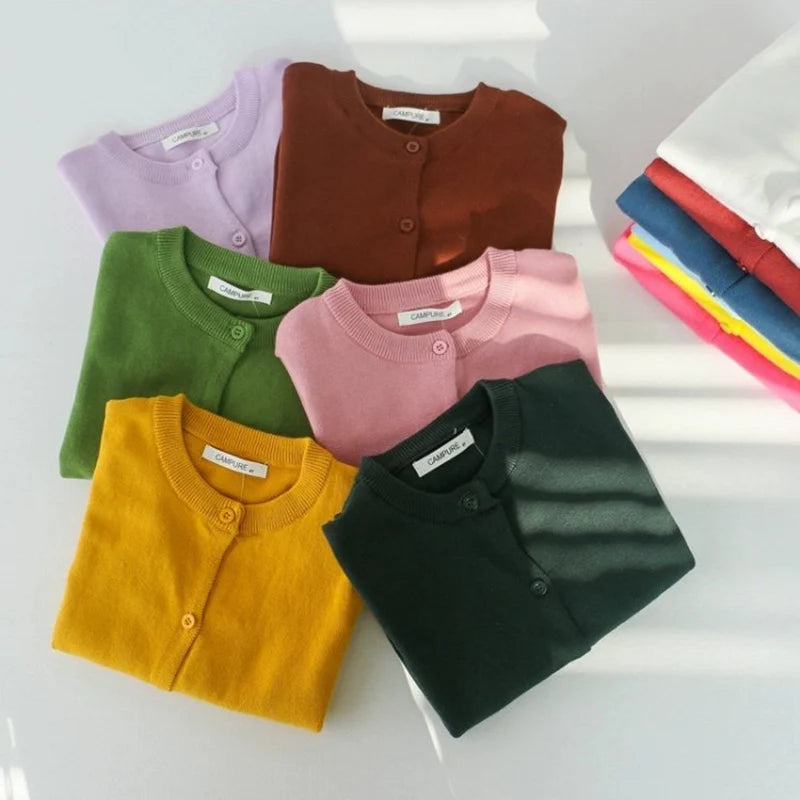 Set of colorful folded shirts on a white background