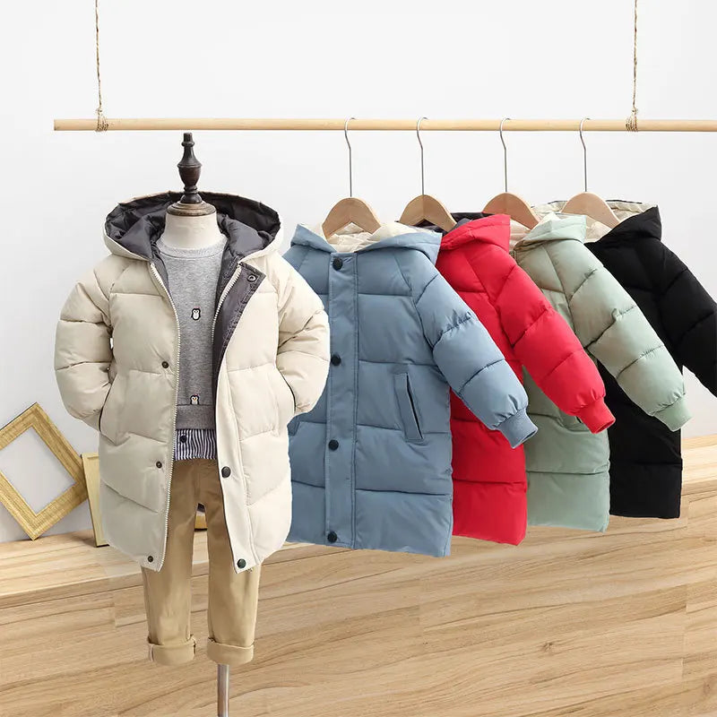 Row of colorful children's puffer jackets on hangers against a light background