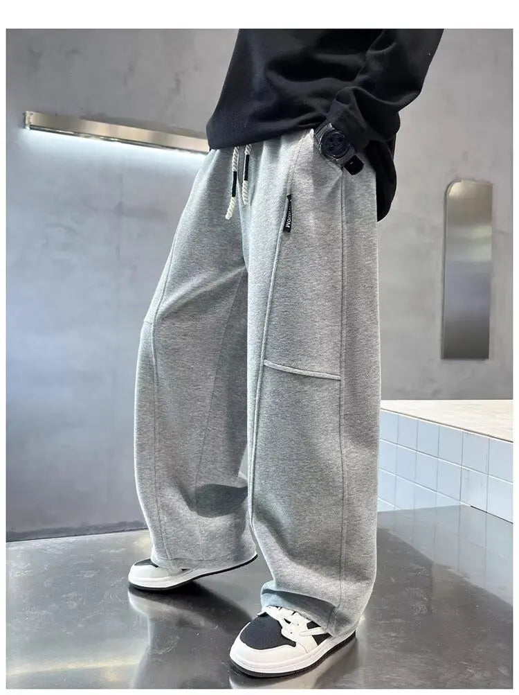 Person wearing gray sweatpants in a modern indoor setting