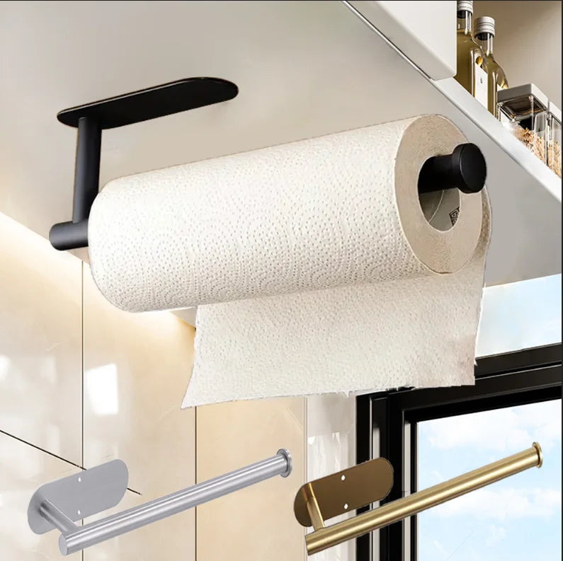 Roll of paper towels on a black holder with a kitchen setting in the background