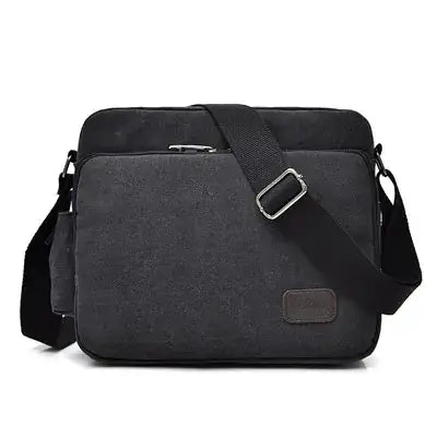 Black shoulder bag with a strap on a white background