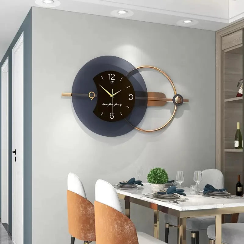 Modern wall clock on a gray wall above a dining table with chairs.
