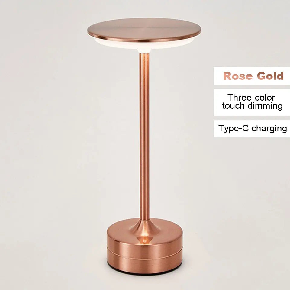 Rose gold LED table lamp with text indicating features on a light gray background