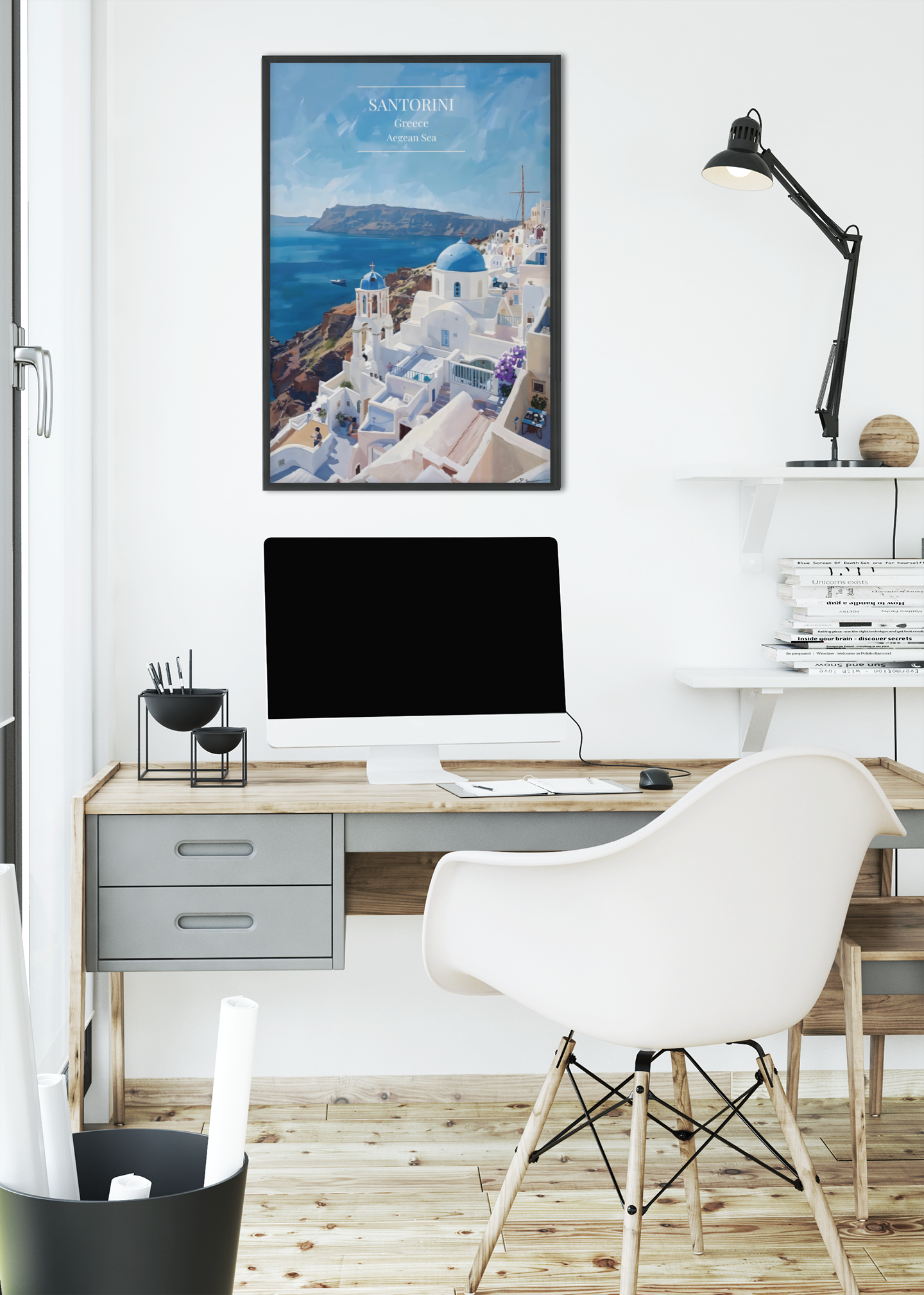 Modern home office with a desk, chair, computer monitor, and framed picture of Santorini.