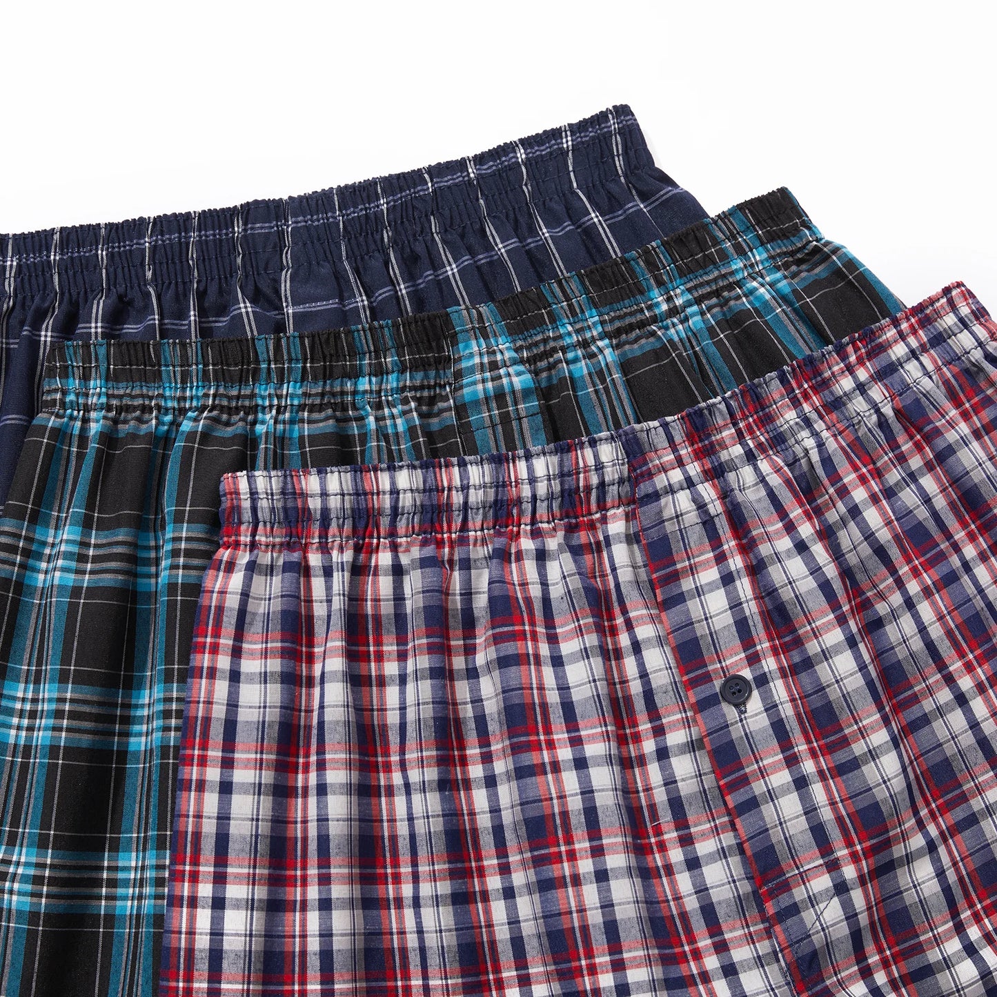 Three pairs of plaid boxer shorts in different patterns on a white background