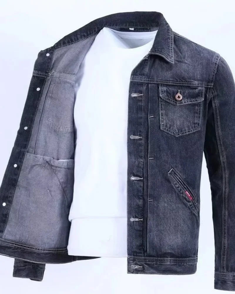 Denim jacket with a white shirt underneath on a light gray background