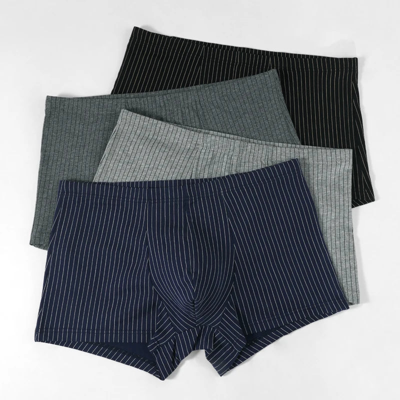 Four pairs of men's boxer briefs in different patterns on a white background