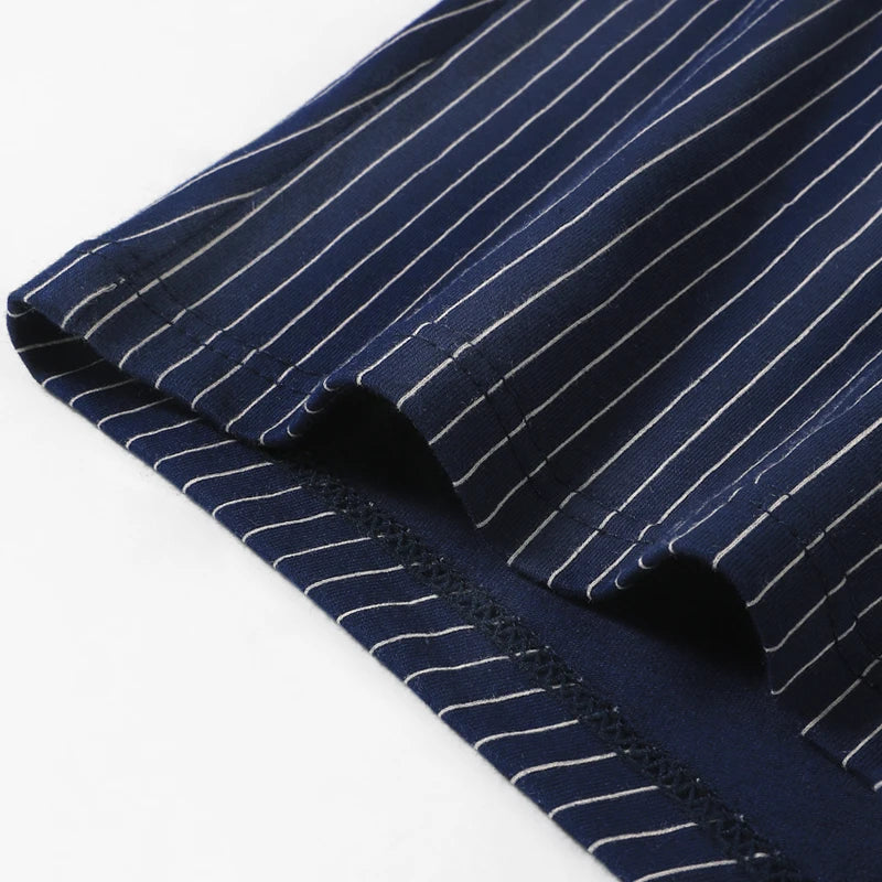 Close-up of navy blue fabric with white pinstripes on a white background