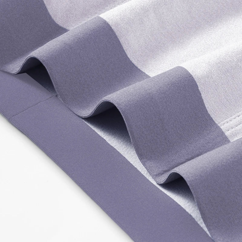 Close-up of gray fabric with a subtle pattern on a light gray background