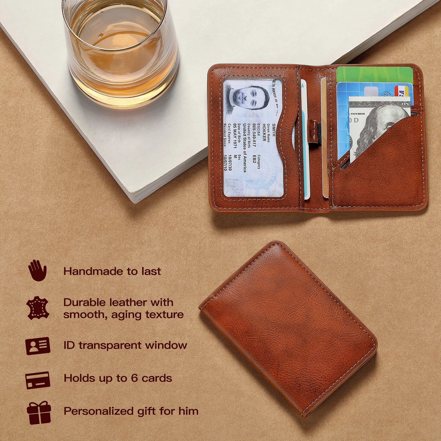 Brown leather wallet with cards on a beige surface with a glass of whiskey.