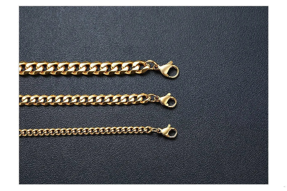 Three gold chain necklaces on a dark gray background