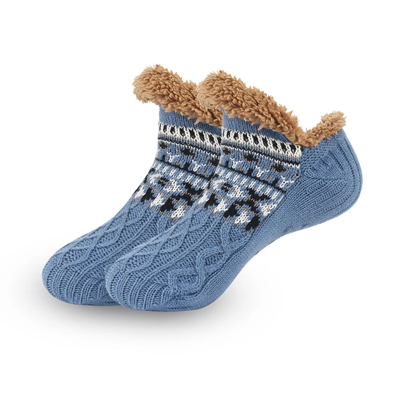 Blue knitted socks with brown fuzzy trim on a white background