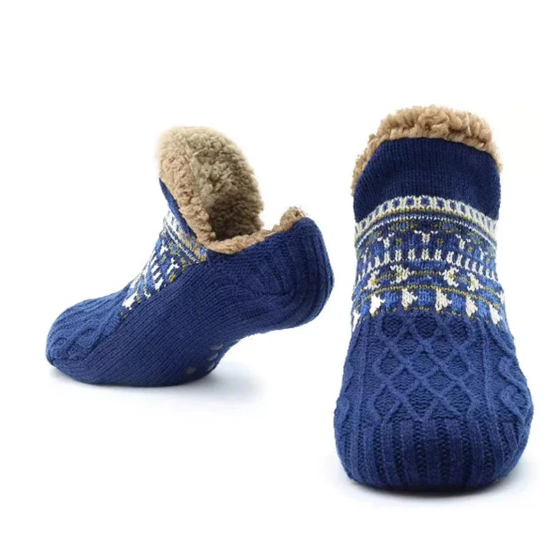 Pair of blue slipper socks with patterned design and brown fur lining on a white background