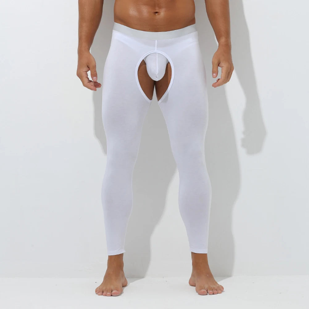 Person wearing a white thong and leggings on a plain background