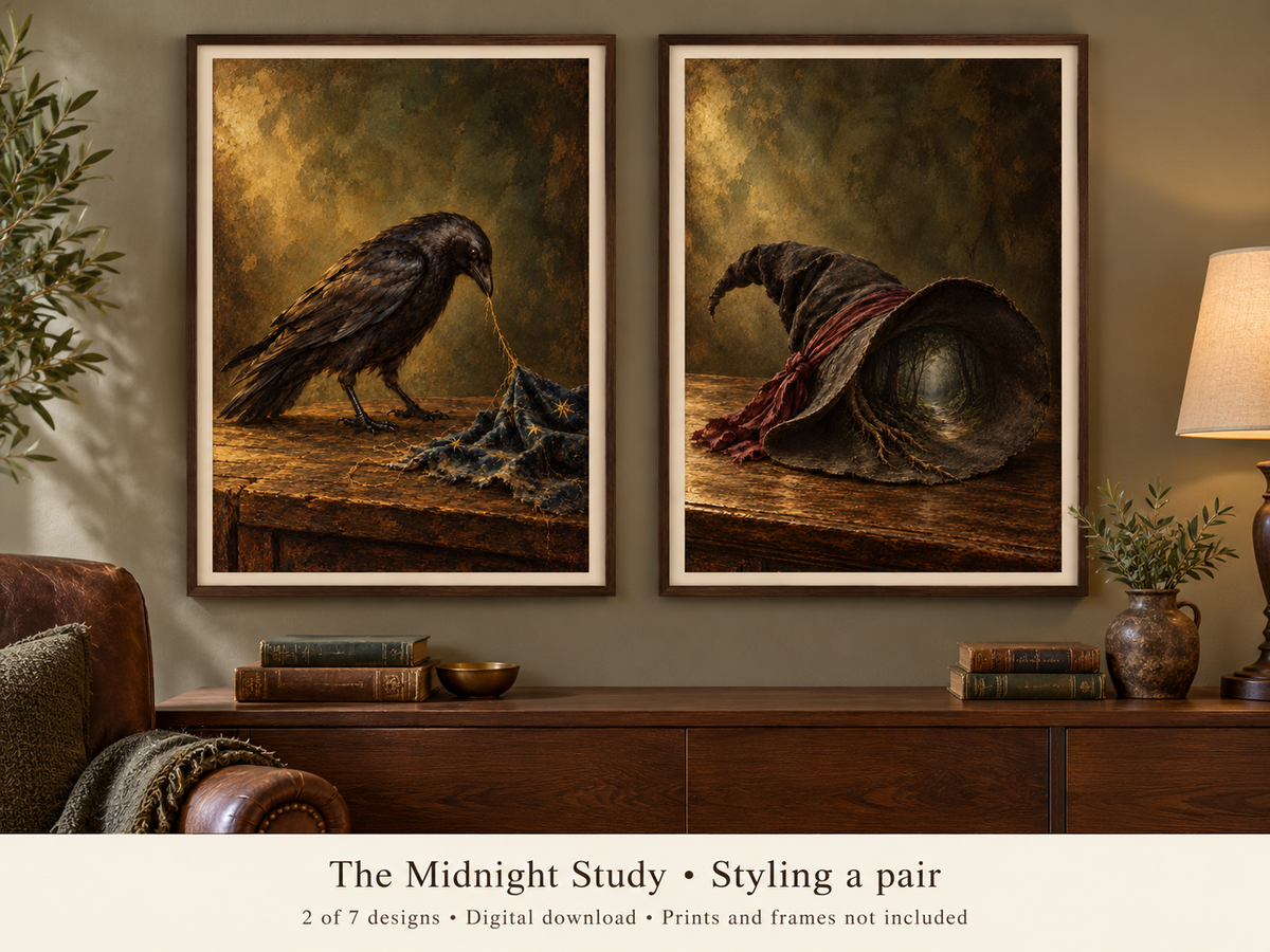 Two framed art prints depicting a raven and a witch's hat in a dark, moody still-life style, displayed side by side on a wall above a wooden console table in a styled room. Text at the bottom reads 'The Midnight Study • Styling a pair' and '2 of 7 designs • Digital download • Prints and frames not included'.