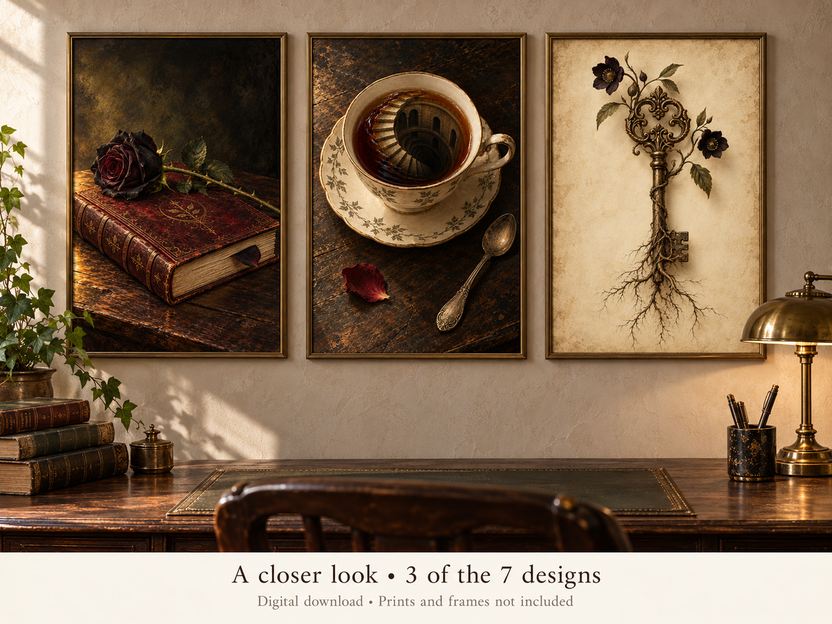 Three framed wall art prints displayed above a wooden desk in a styled interior. The left print shows a dark rose resting on an old book; the center print shows a teacup and saucer with a spiral staircase inside; the right print shows a vintage key with roots and flowers.
