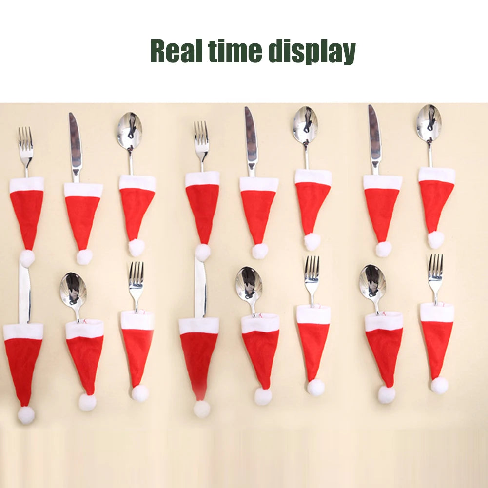 Set of silverware with Santa hats on a beige background