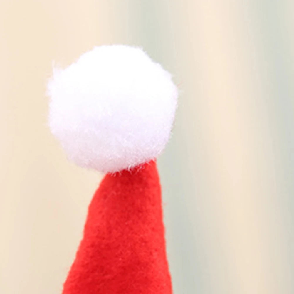 Red Santa hat with white pom-pom on a beige background