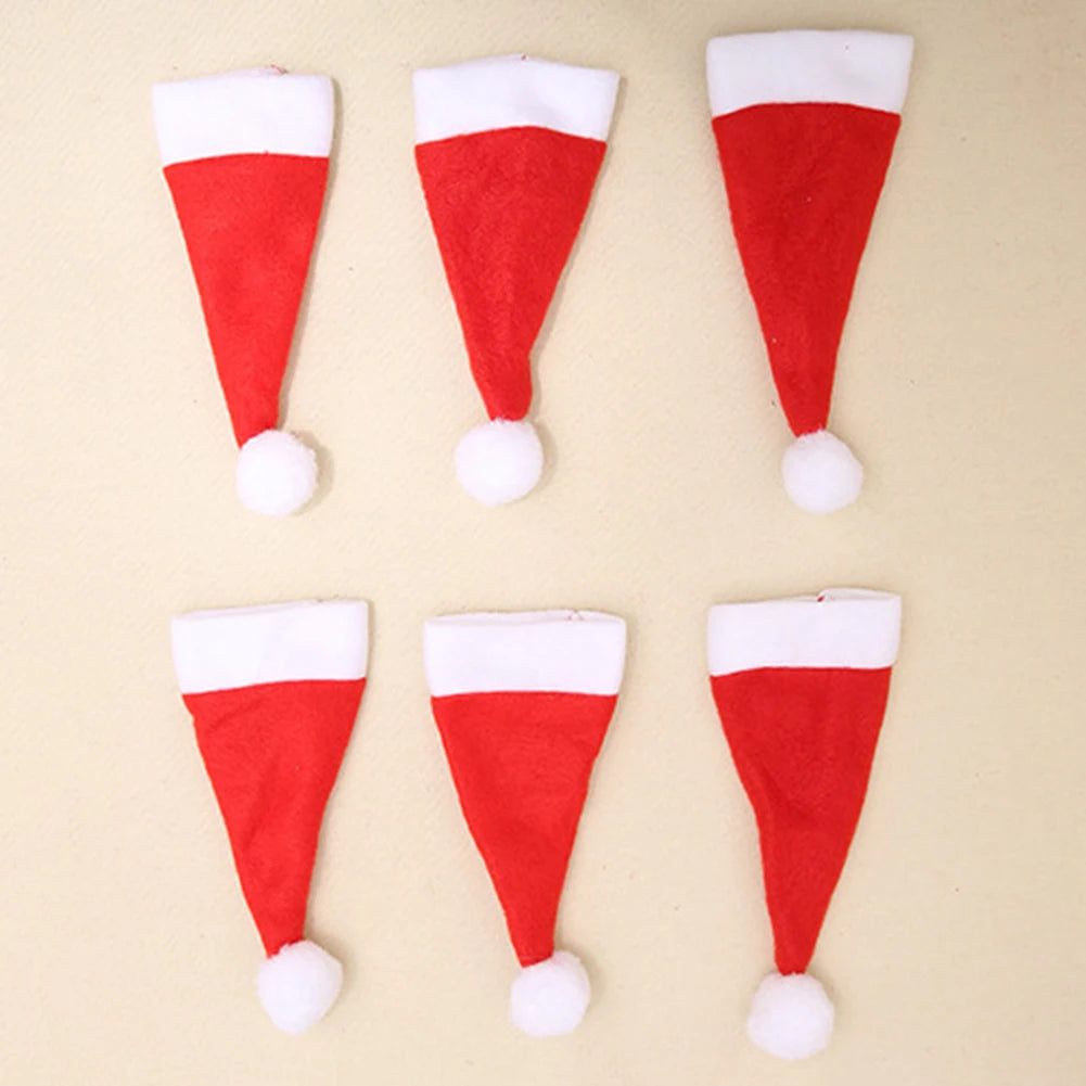 Six red and white Santa hats on a beige background