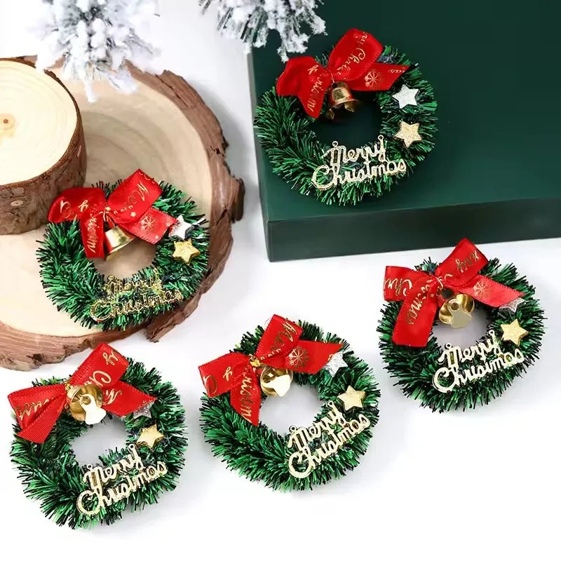 Set of small Christmas wreaths with red bows and 'Merry Christmas' text on a white surface.