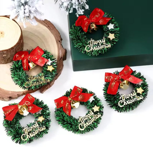 Set of small Christmas wreaths with red bows and 'Merry Christmas' text on a white surface.