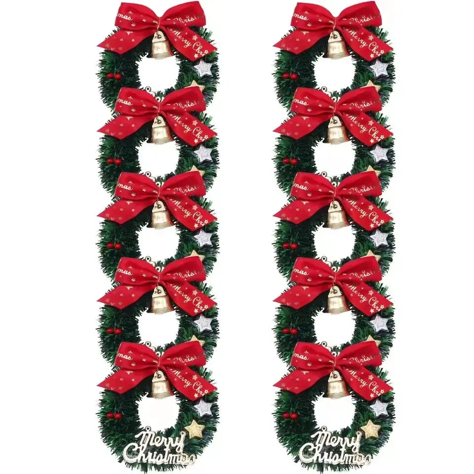Two Christmas garlands with red bows and gold bells on a white background