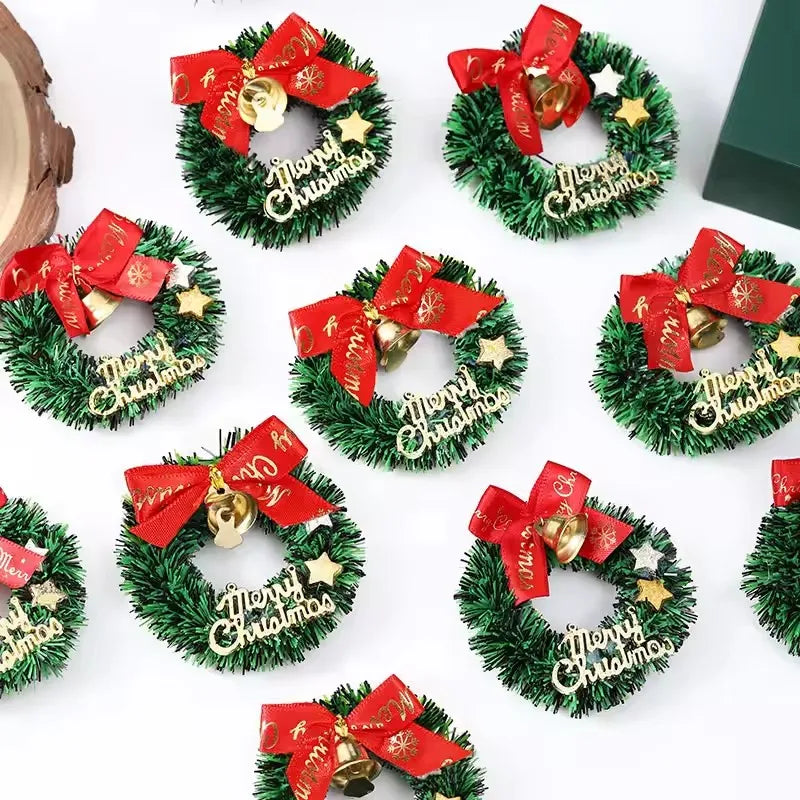 Small Christmas wreaths with red bows and 'Merry Christmas' text on a white background
