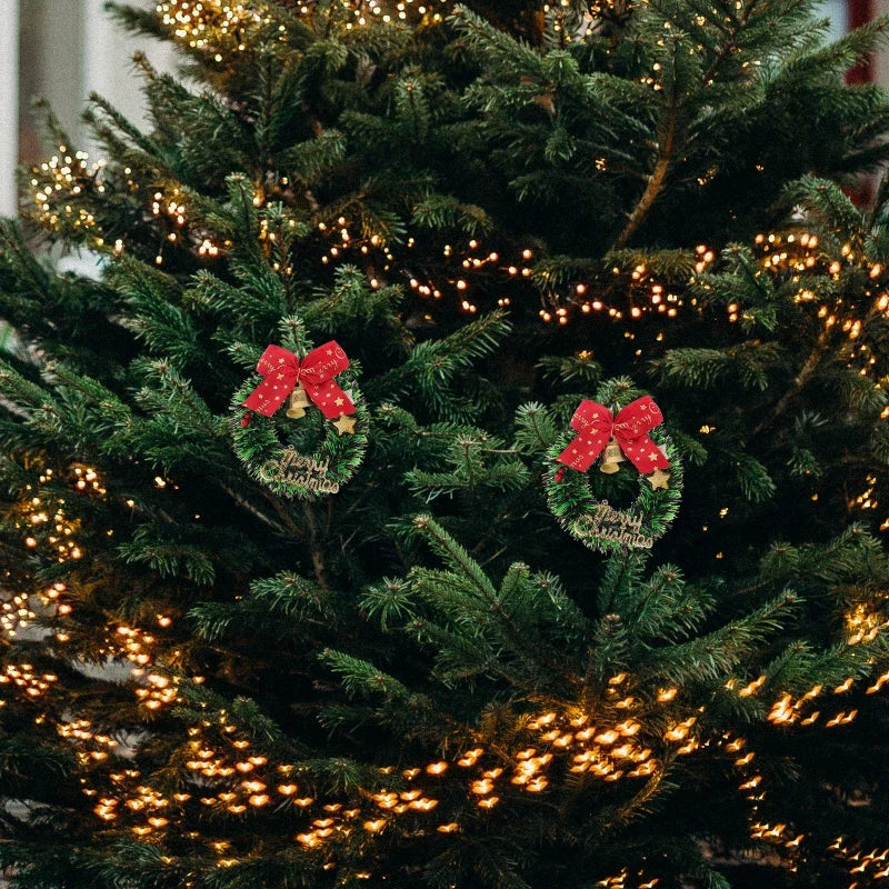 Decorative wreaths with red bows on a lit Christmas tree