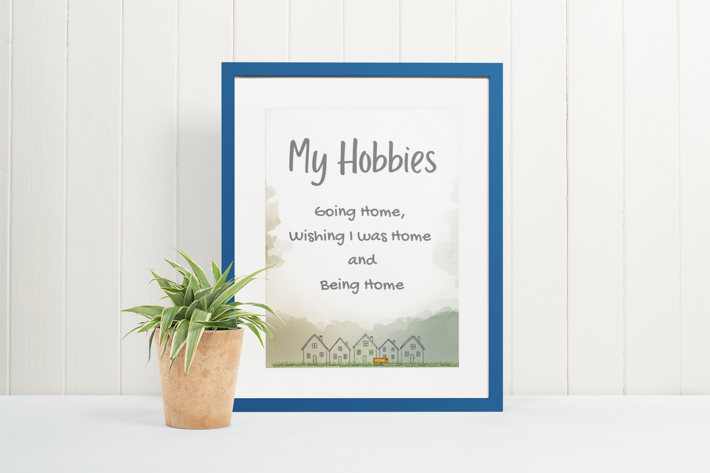 Cozy typography printable wall art featuring “My hobbies include going home, wishing I was home, and being home” with hand-drawn house illustrations