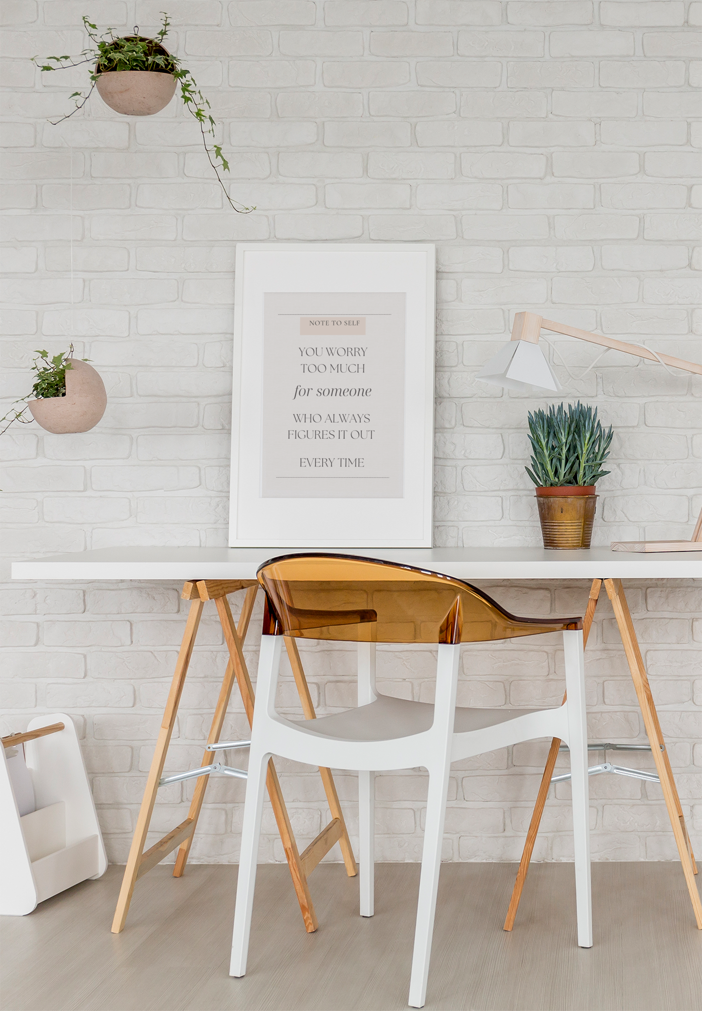 Modern interior with a white brick wall, wooden table, and transparent chair.