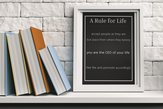 modern black typography poster displayed on shelf with books and decor