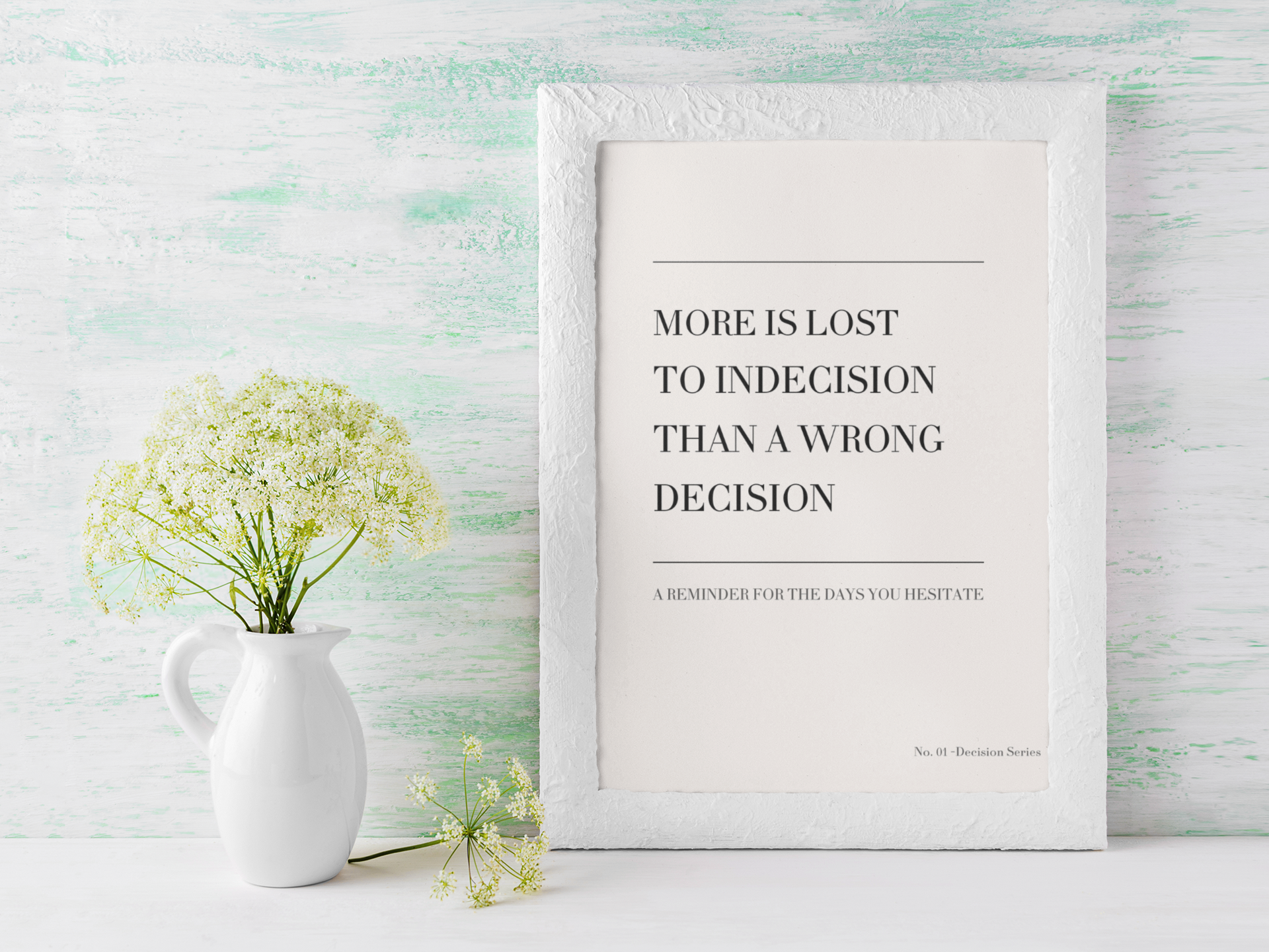 Minimalist typography wall art with indecision quote styled in bright modern interior with vase