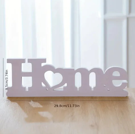 Decorative sign with 'Home' text on a wooden surface