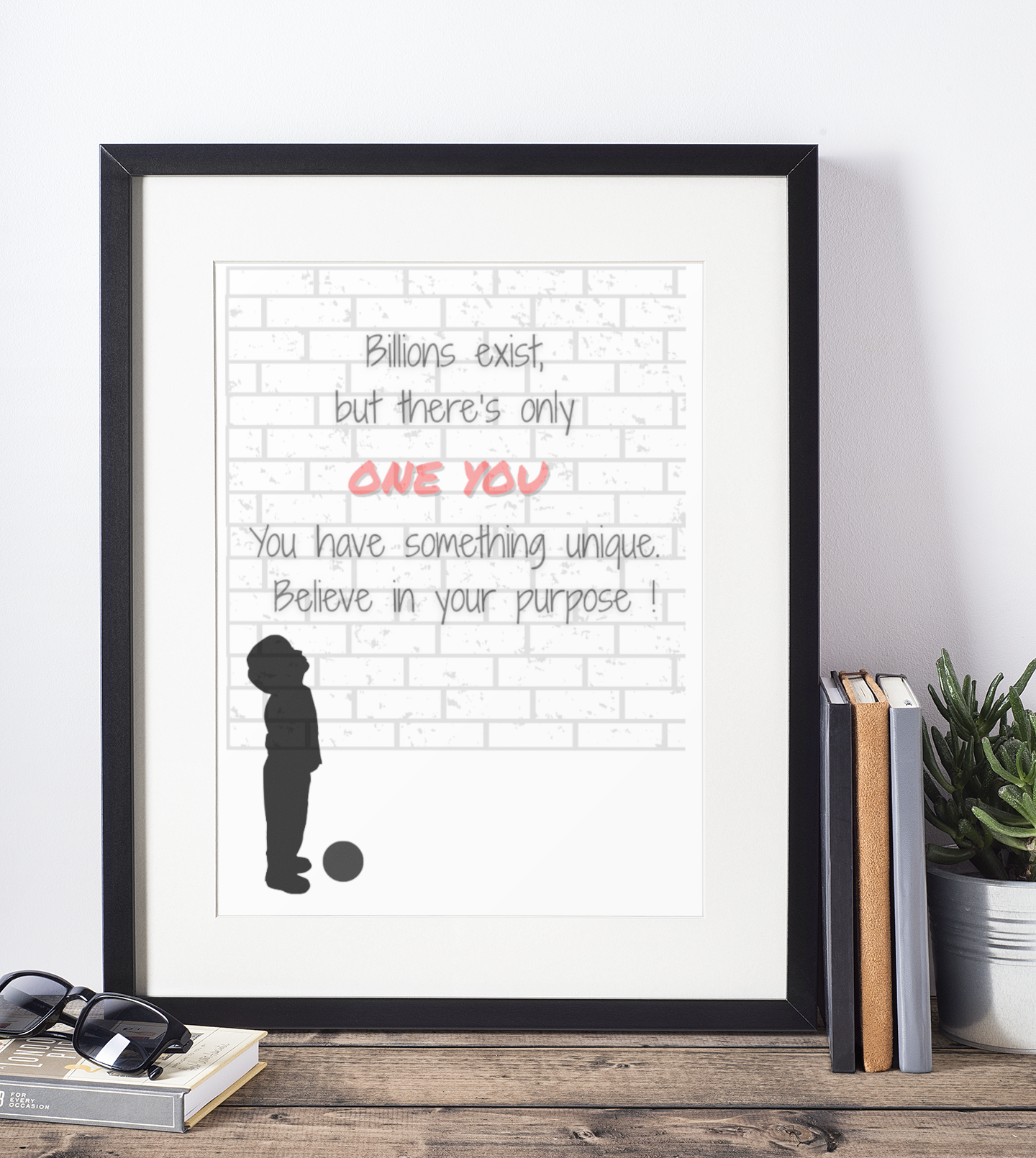 Framed motivational poster with text and silhouette on a white wall.