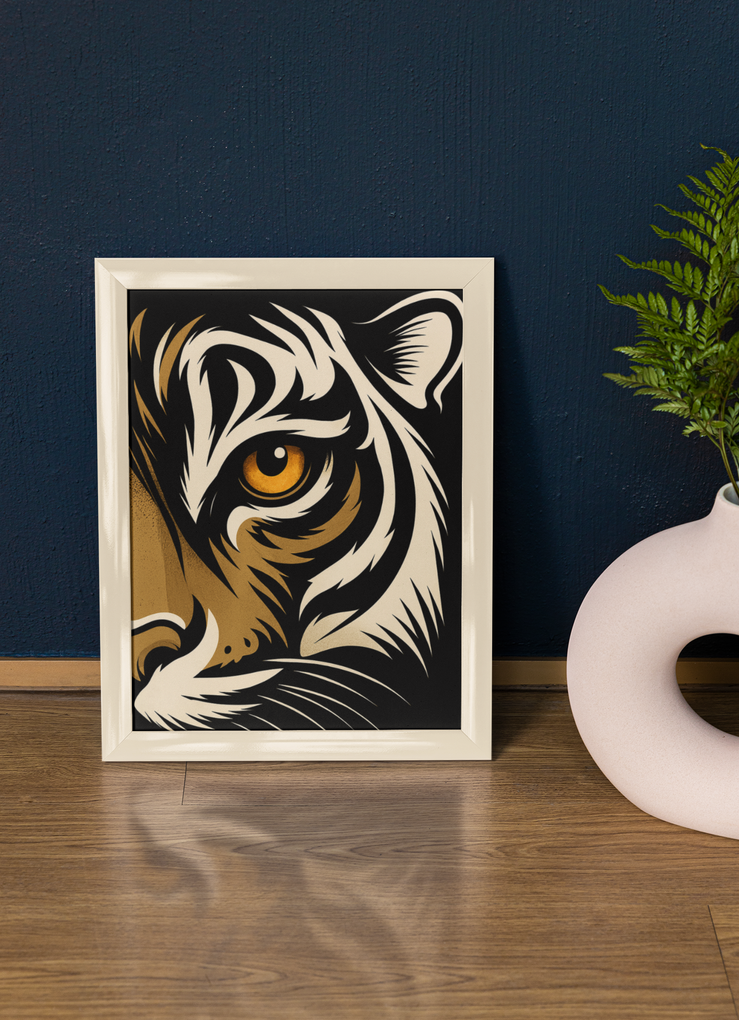 Framed artwork of a tiger's face on a wooden surface with a dark blue wall background.