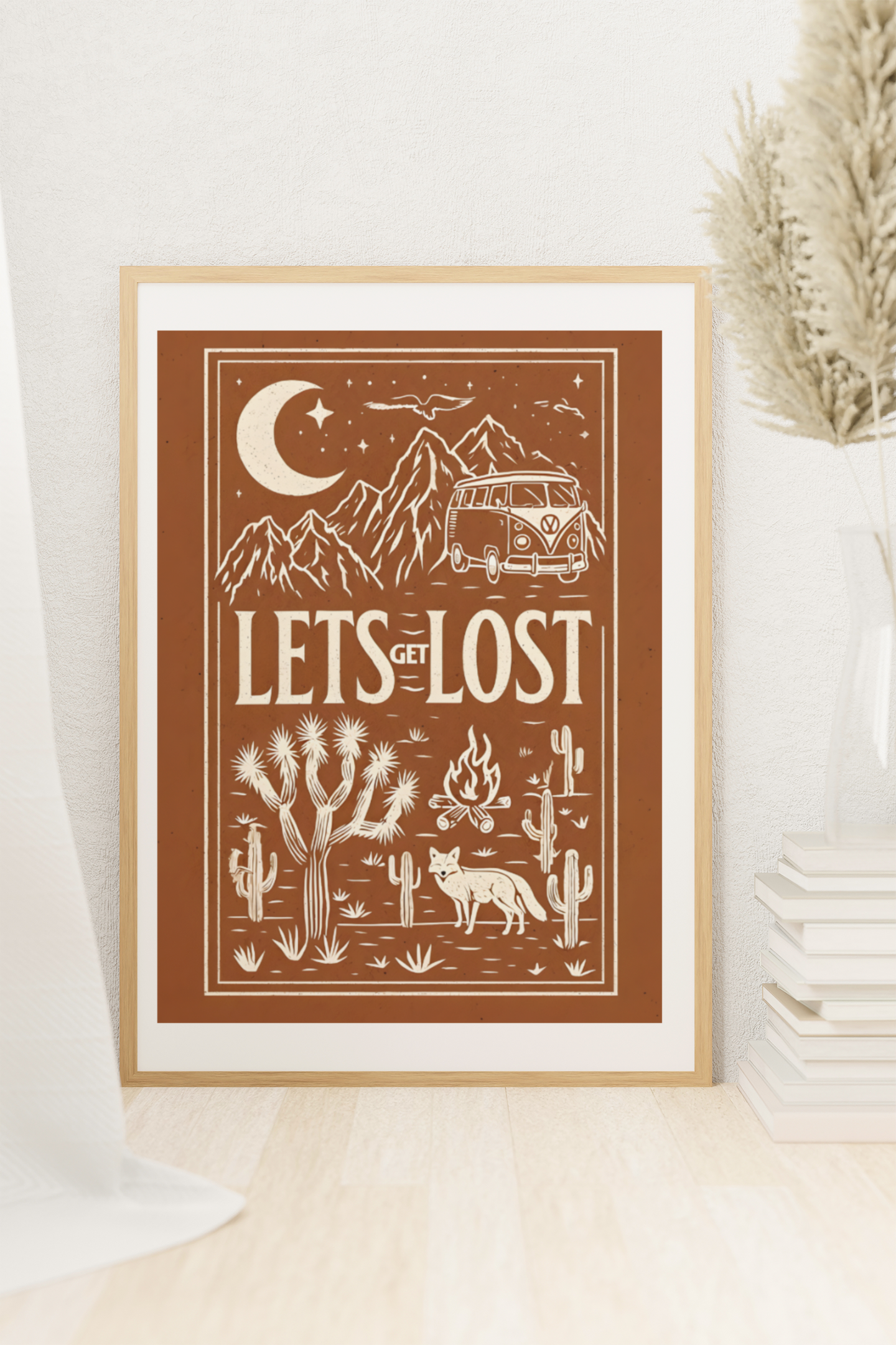 Let’s Get Lost retro travel poster with camper van and desert scene, framed in light wood and styled with books and plants in a cozy room