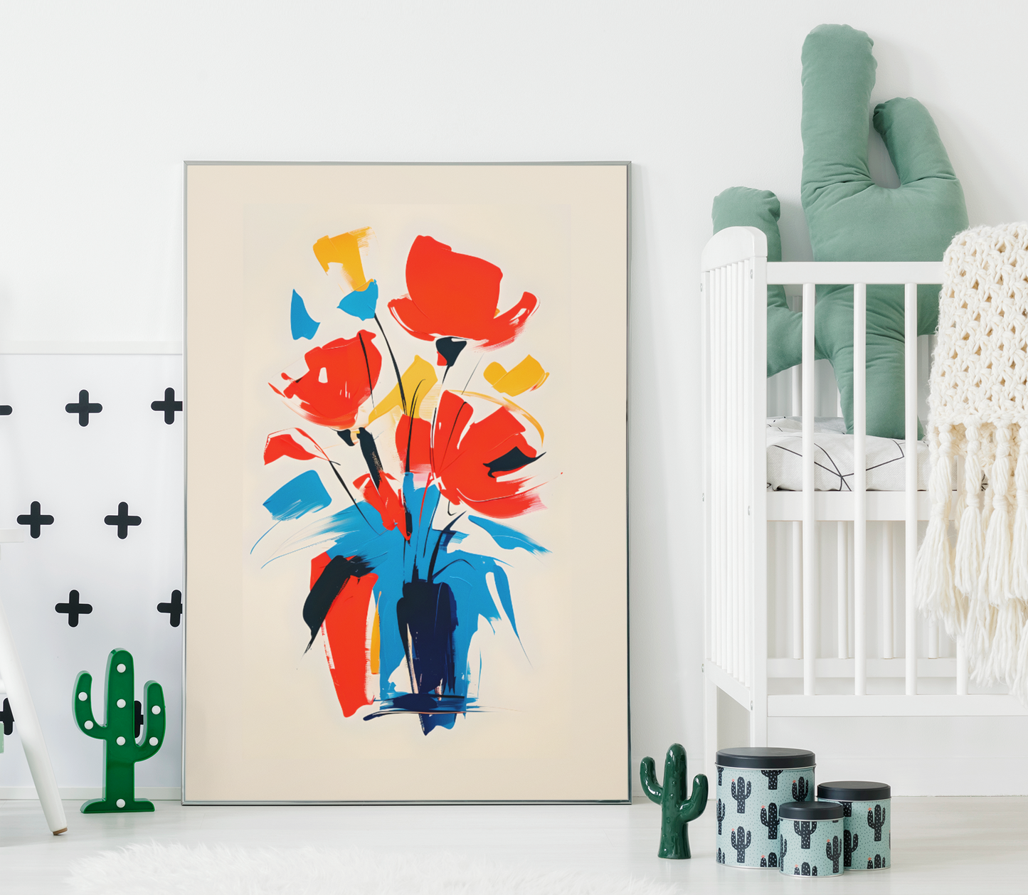 Abstract floral poster with bold red, yellow, and blue bouquet – colorful modern wall art displayed in bright nursery with crib and cactus décor.