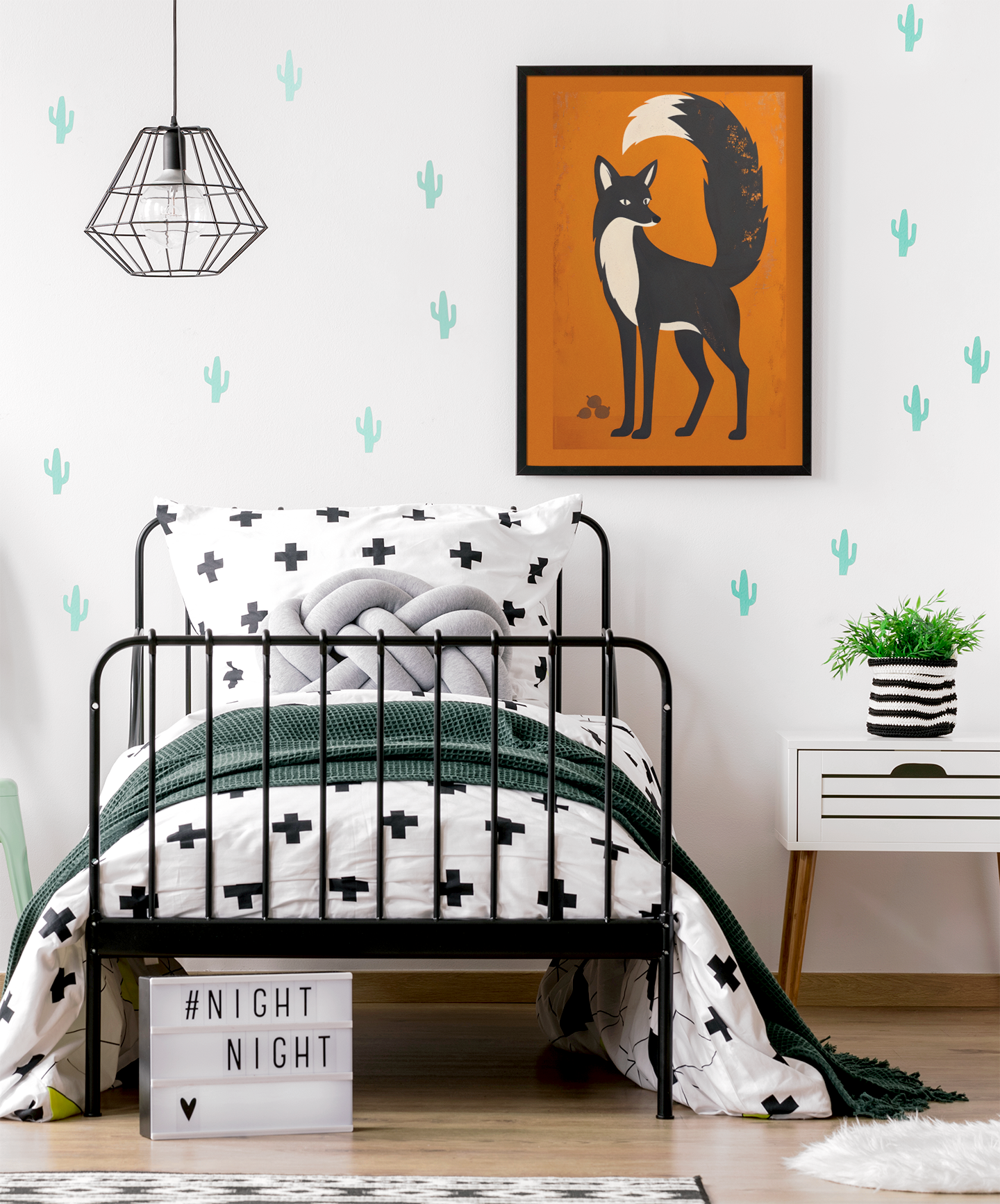 Children's bedroom with a black metal bed, fox artwork on the wall, and cactus wall decals.