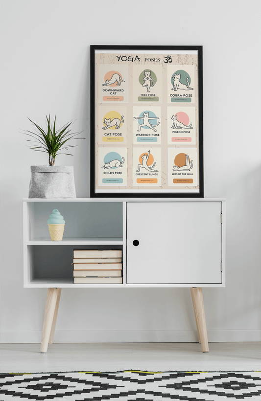 Framed minimalist cat yoga wall art poster featuring 9 illustrated feline poses in soft pastel colors, styled in a modern home interior.