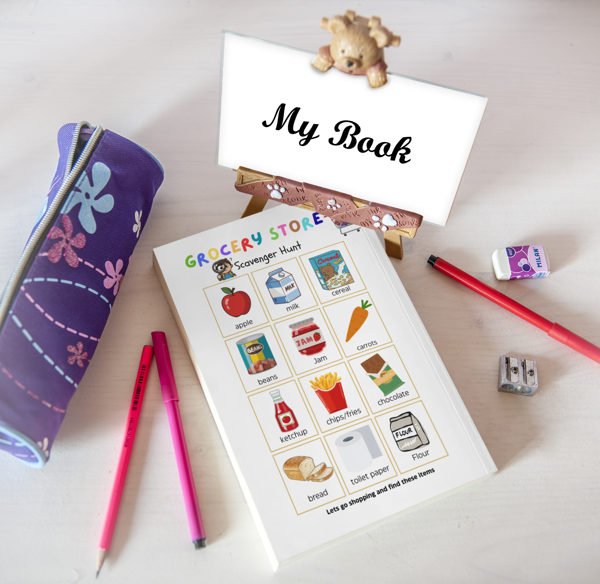 Children's activity book with coloring pages and stationery items on a light surface