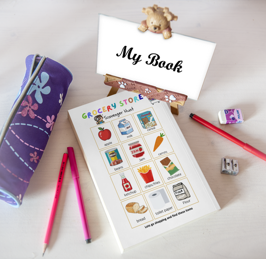 Children's activity book with coloring pages and stationery items on a light surface