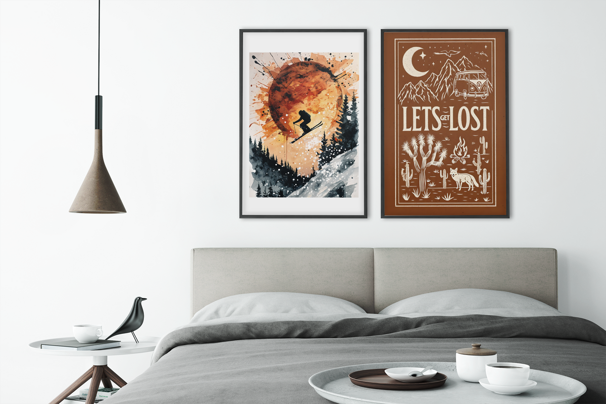 Two framed artworks above a bed in a bedroom setting.