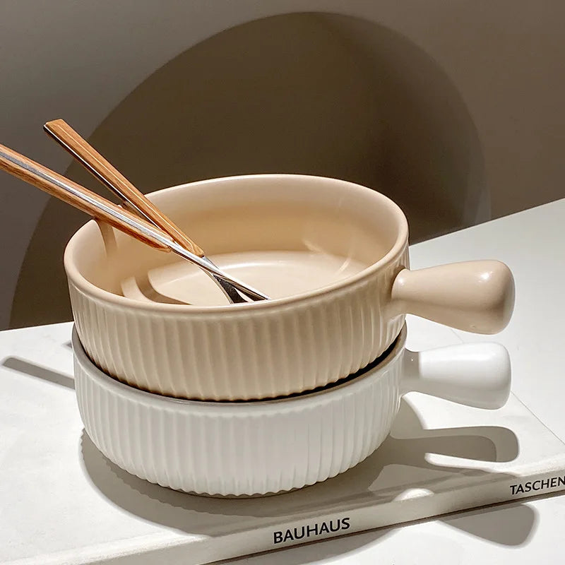 Set of ceramic bowls with handles on a white surface, featuring the Bauhaus brand.